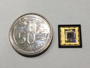 A test chip for a sensor node processor based on cognitive sensing technology. A 50-cent coin has been placed next to the chip for size comparison.