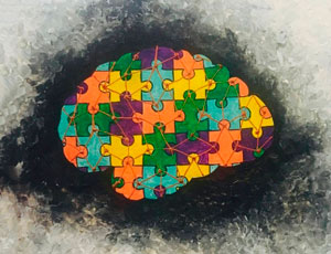 A graphical representation of autism, depicting the brain using puzzle pieces — the universal symbol for autism that signifies the complexity and lack of understanding about the disease.