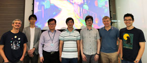 The IMRE and DSI team involved in this research, standing in front of their reproduction of Kandinsky's Murnau Street with Women.